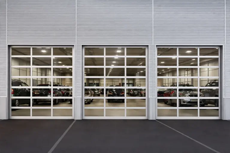High-lift full view sectional door installed in an automotive sectional, providing maximum vertical clearance and full glass visibility for vehicle storage