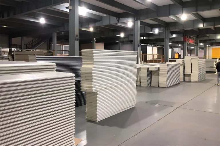 Stacks of heavy-duty commercial garage door panels and insulated PU sandwich panels ready for wholesale distribution at the ABX manufacturing facility.